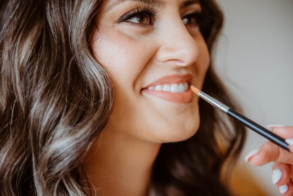 bride gets her wedding makeup done 